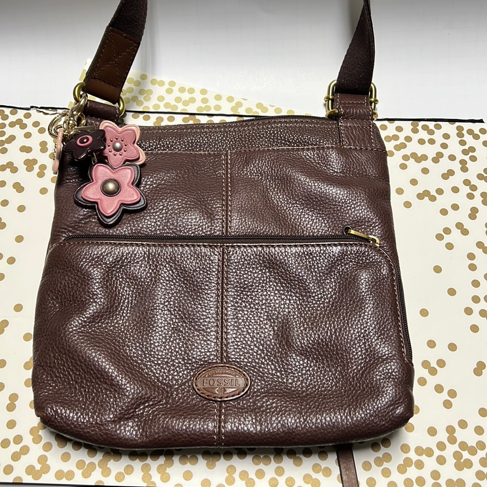 Brown leather Fossil crossbody with pink and burgundy keychain